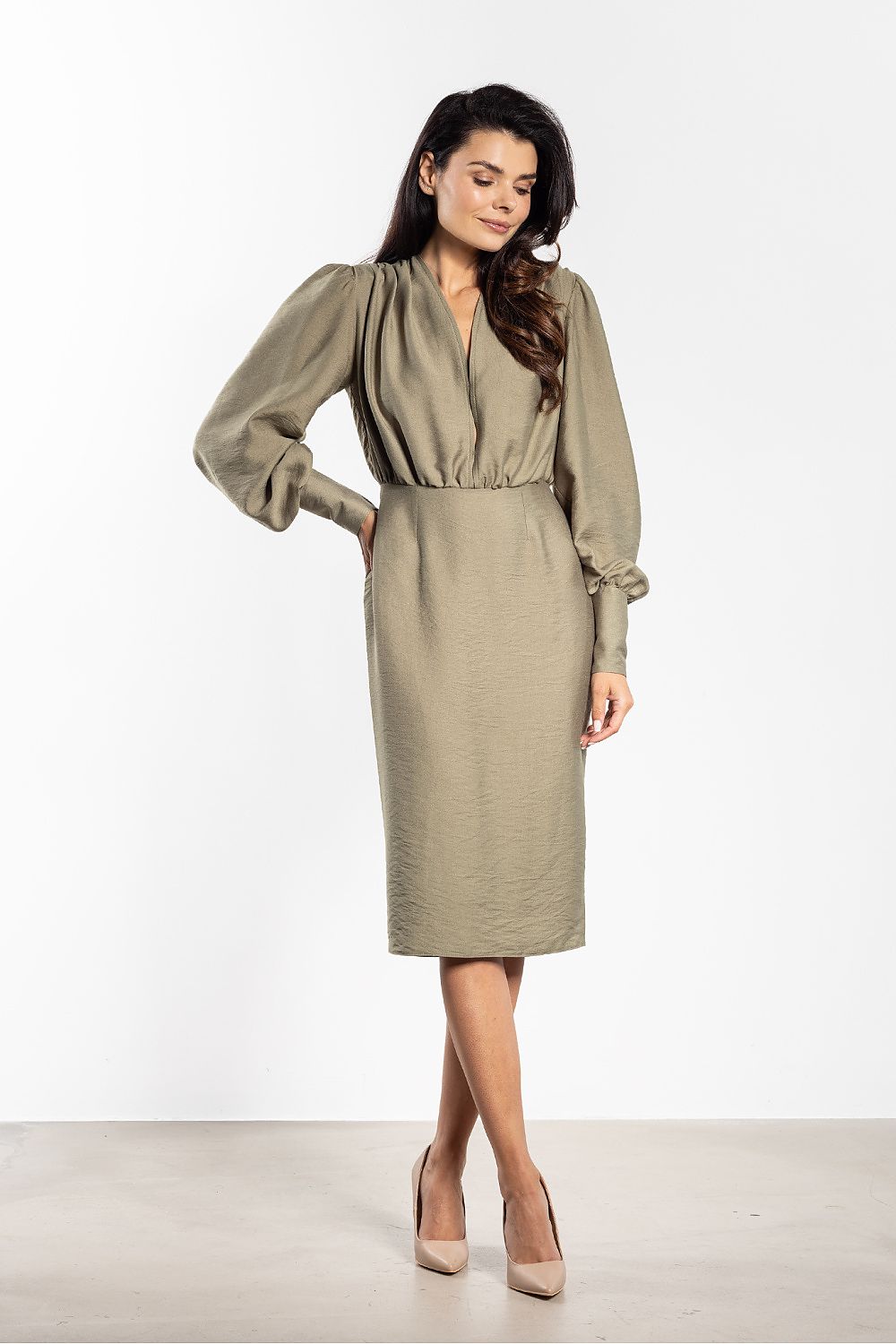 Side view of Awama's elegant midi dress showcasing its fitted silhouette and stylish knee-length design.