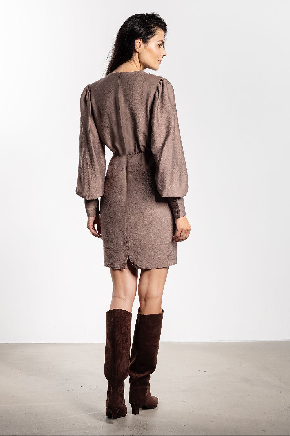 Model wearing Awama's elegant mini cocktail dress, highlighting its stunning silhouette and perfect fit for parties and events.