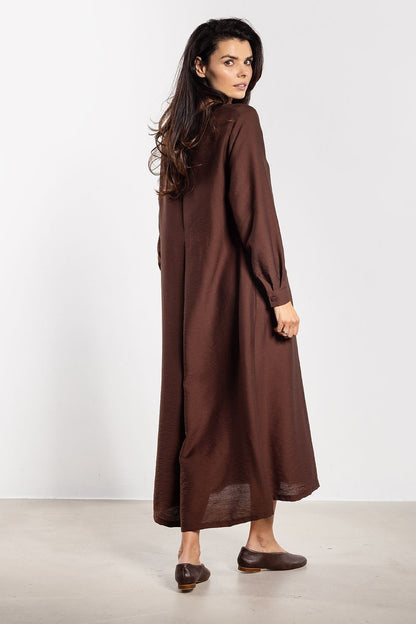 Elegantly modern A-Line maxi dress with belt by Awama, available in sizes S, M, L, XL, showcasing a minimalist design with a row of small buttons and long sleeves for versatile styling.