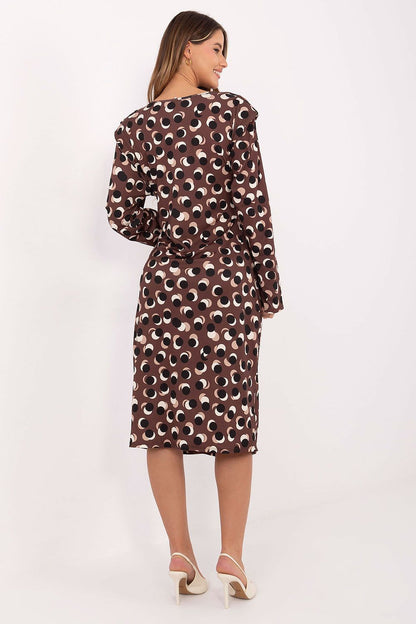 Model wearing an elegant midi dress with shoulder pads and geometric design by Rue Paris, ideal for both formal and casual occasions.