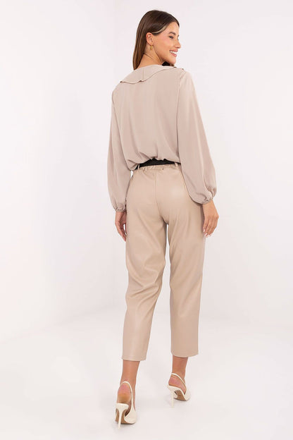 Stylish Rue Paris high waist leatherette trousers worn with a chic top, demonstrating versatile outfit options for modern women.