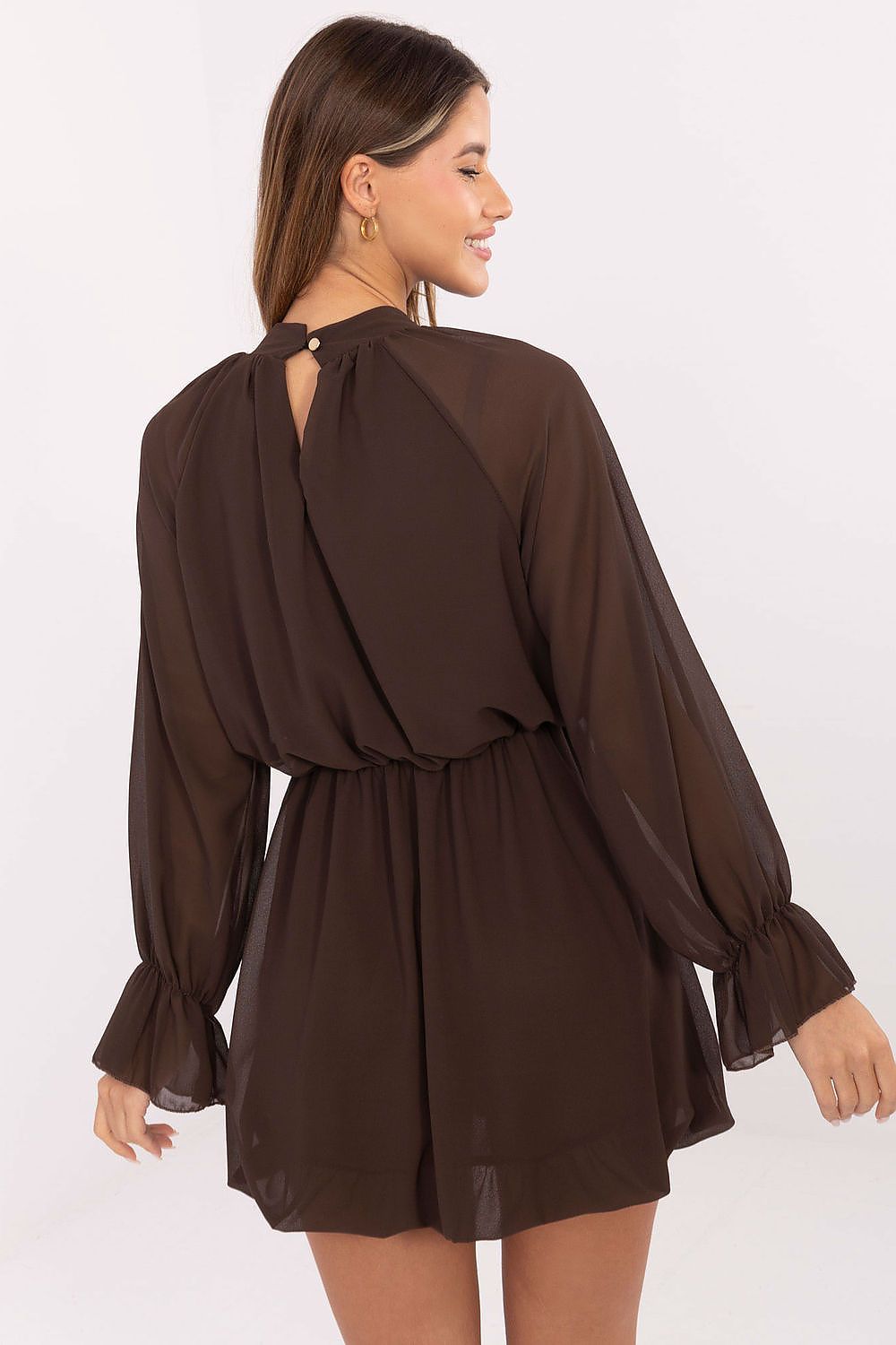 Stylish model wearing Rue Paris mini cocktail dress, captured in a fashionable pose at a festive gathering, embodying elegance and charm.