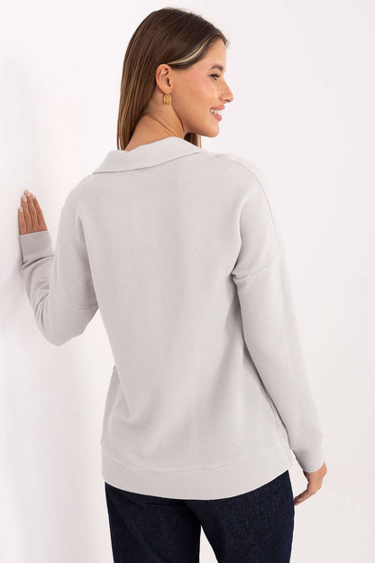 A stylish woman wearing the Lakerta women's polo shirt, complementing her outfit with versatility for both professional and casual settings.