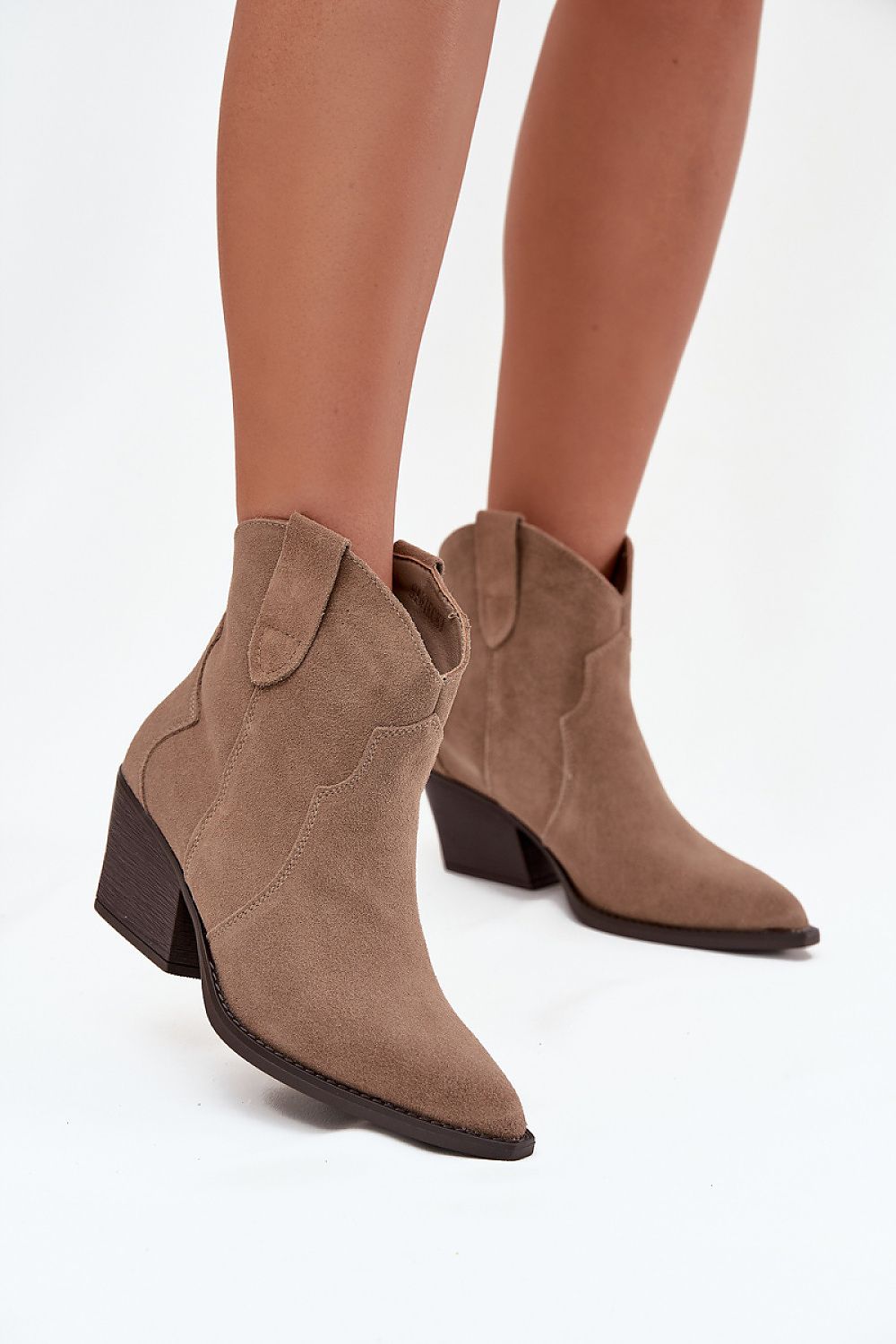 Step in Style luxurious women's suede ankle boots, ideal for pairing with jeans or dresses, highlighting their unique cowboy-inspired silhouette.