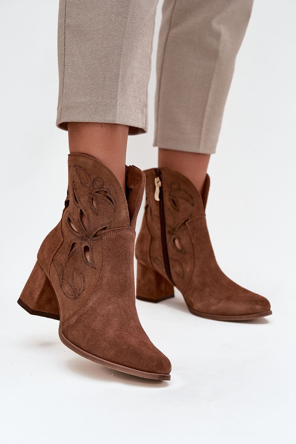 Fashionable women's ankle boots by Step in Style in natural leather, highlighting intricate lacy patterns and a sophisticated silhouette.