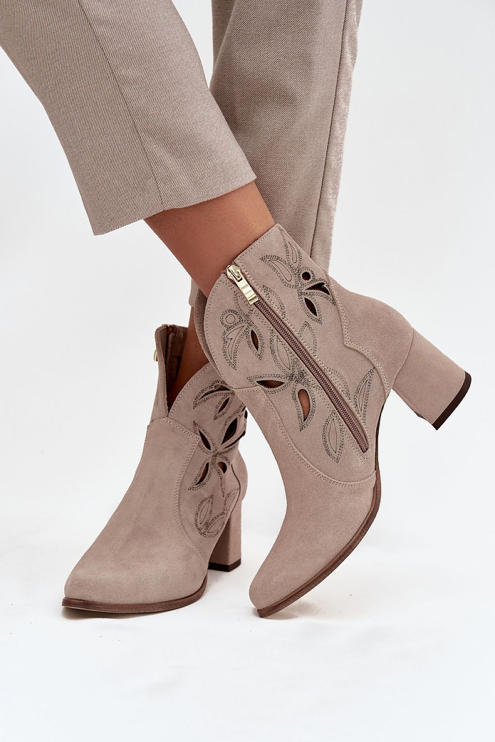 Stylish women's ankle boots from Step in Style, showcasing a sleek silhouette with a high column heel and chic zipper closure for easy wear.