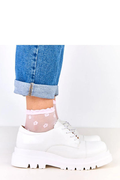 Close-up of Solea eco-leather slip-on shoes showcasing the unique rubber laces and luxurious rounded toe for added comfort and style.