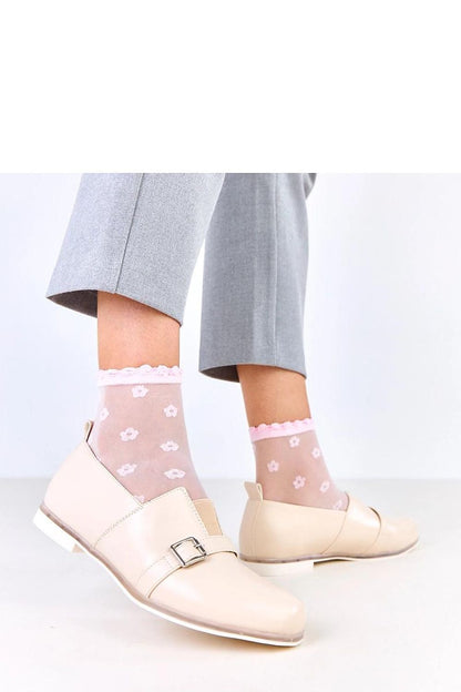 Close-up view of the eco-leather slip-on shoes by Solea featuring an eye-catching decorative buckle and sleek round toe design.