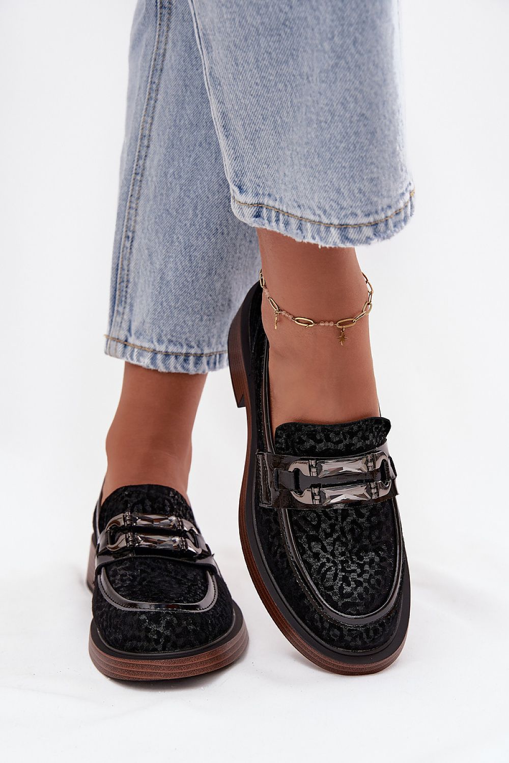 Close-up view of luxurious suede moccasins from Step in Style, showcasing the intricate crystal embellishment and comfortable rounded toe design.