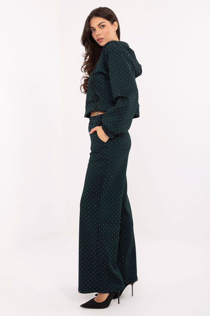 Close-up of Rue Paris elegant women's tracksuit set, highlighting the luxurious texture and jet application detail on the zip-up hoodie and high-waisted pants.