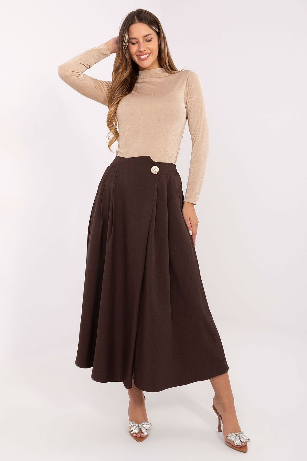 Elegant midi skirt by Rue Paris featuring pleated front detail, showcased in a refined setting.