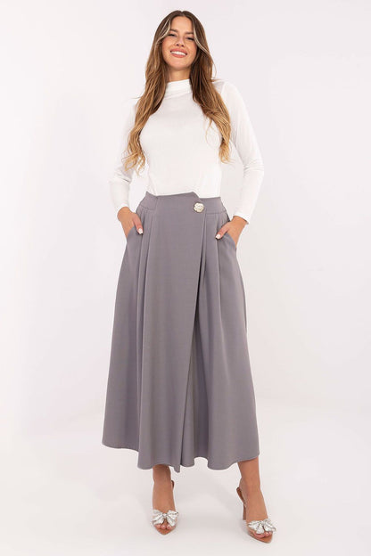The Rue Paris Elegant Midi Skirt worn by a model, demonstrating its versatility for everyday and formal styles in a luxurious setting.