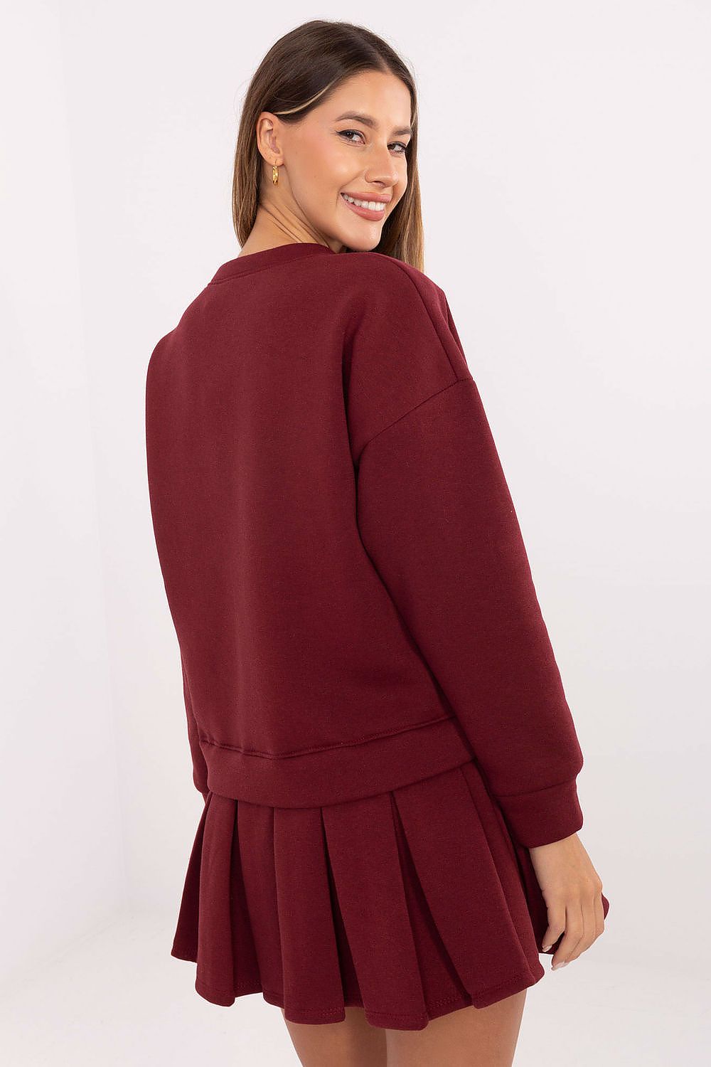 Elegant Rue Paris cotton spandex mini dress featuring a flared cut and pleated bottom, perfect for feminine style.