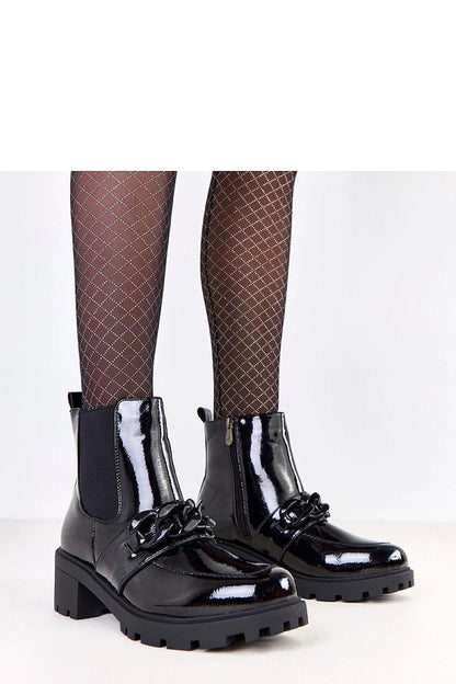 Elegant black ankle boots by Solea, featuring a decorative chain and 5.5 cm heel, crafted from eco-leather for luxurious comfort.