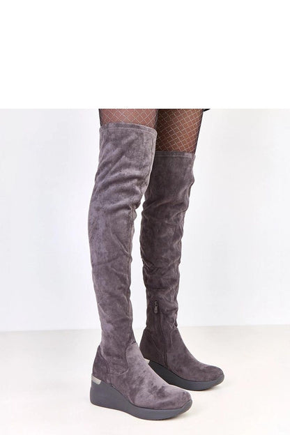 Solea stylish knee-high buskin boots in eco-suede featuring a chic wedge heel, elegantly highlighting legs for a sophisticated look.