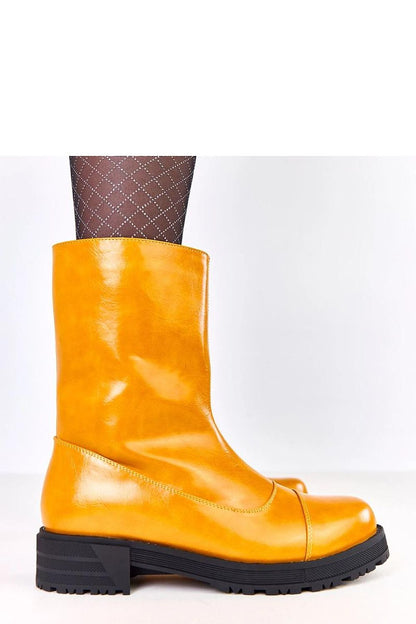 Elegant Solea ankle boots featuring vibrant orange eco-leather, ideal for chic winter looks, with high shaft and insulated comfort.