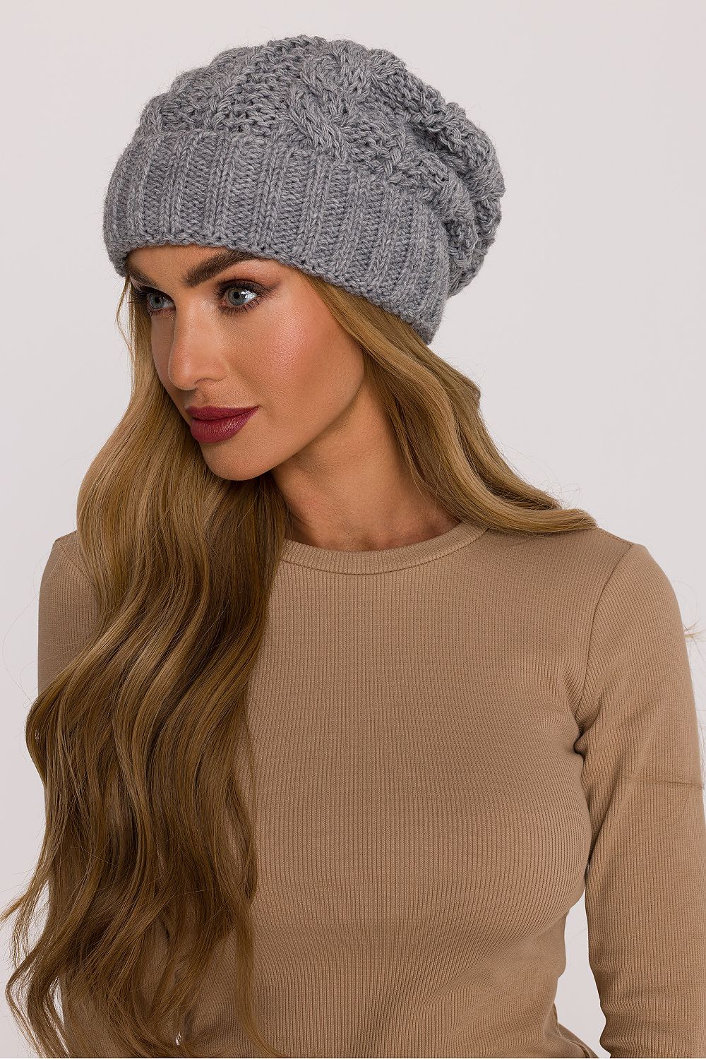 Side angle of the luxury braided knit cap by Moe, emphasizing the casual yet stylish loose fit and classic winter charm perfect for cold weather.