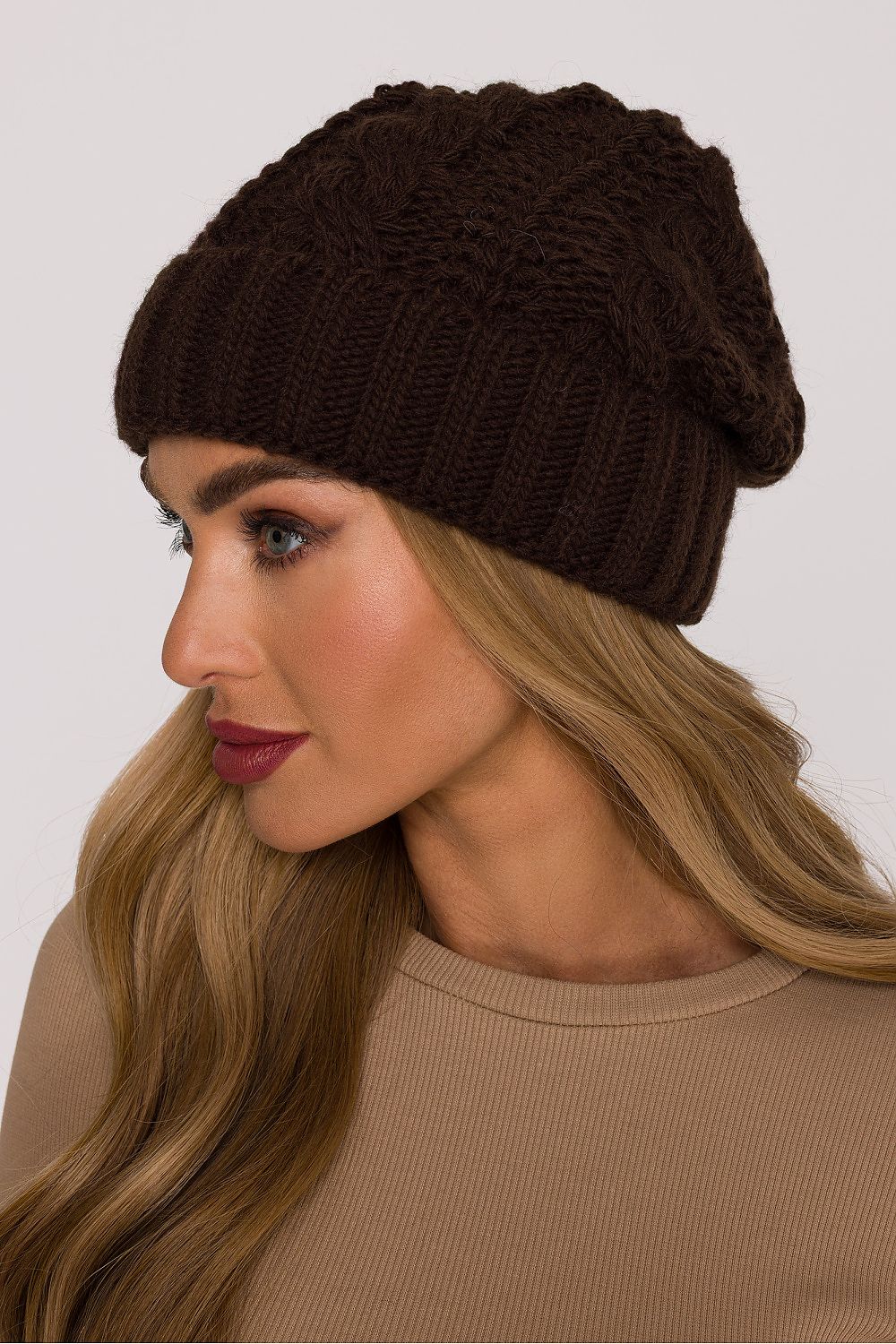 Luxury Braided Knit Cap by Moe displayed against a wintery background, capturing the essence of comfort and timeless winter style.