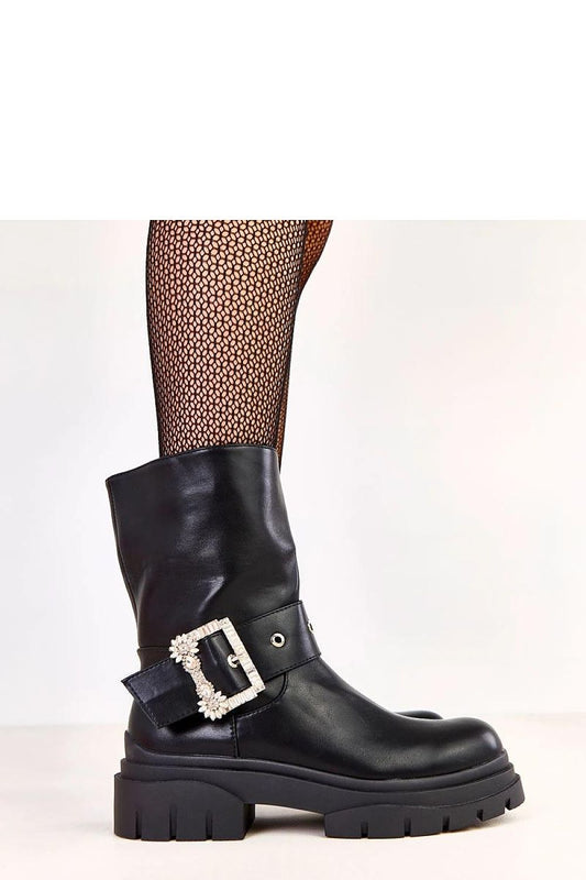 Close-up of Solea women's ankle boots featuring exquisite decorative buckle with zircons, highlighting luxury and fashion.