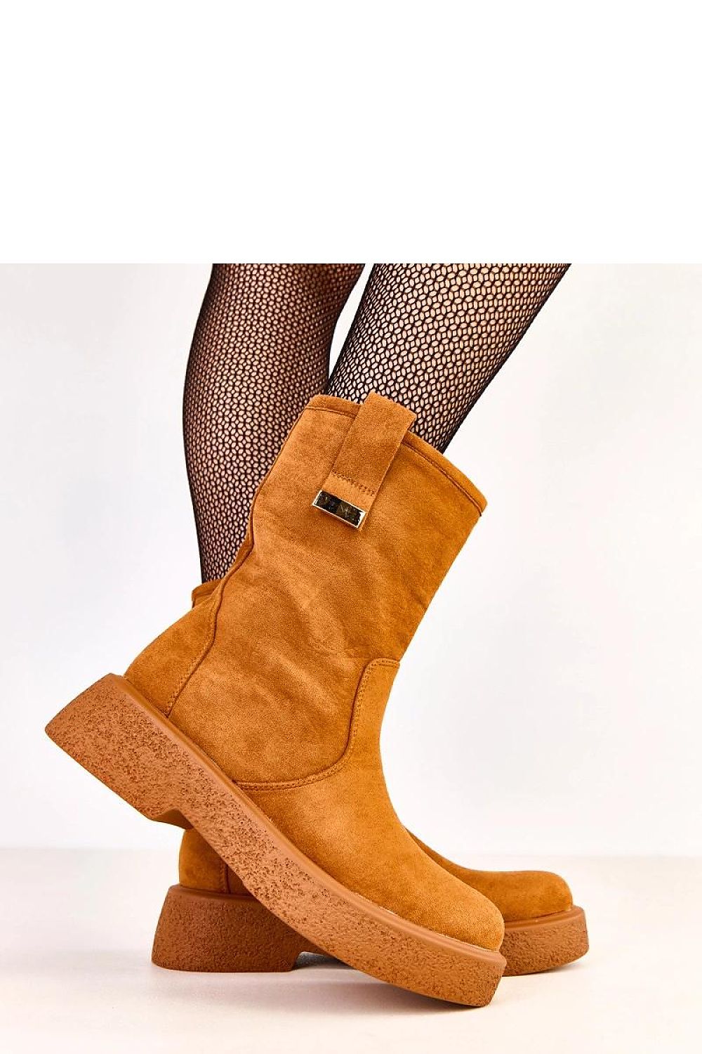 Close-up of eco-friendly suede women's ankle boots by Solea, showcasing unique delicate metal detailing and soft fabric insole for comfort.