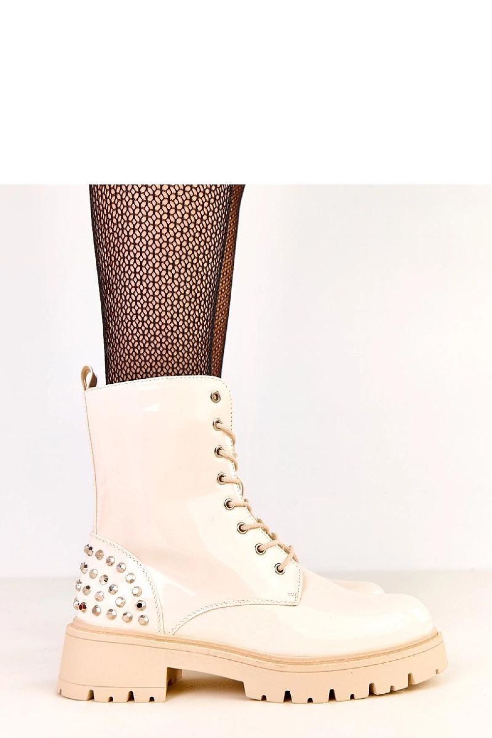 Close-up view of Solea women's ankle boots showcasing the glamorous patent eco-leather finish and decorative jets for a chic, urban style.