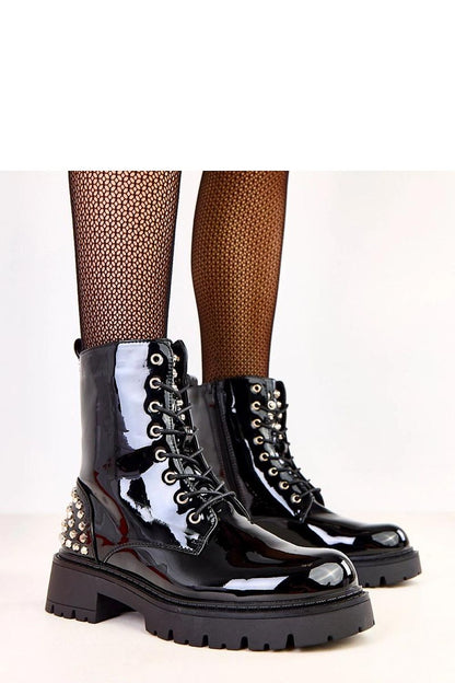 Luxury Solea women's patent leather booties featuring decorative studs, ankle height design, and a sleek 5.5 cm heel, perfect for elegant urban outfits.