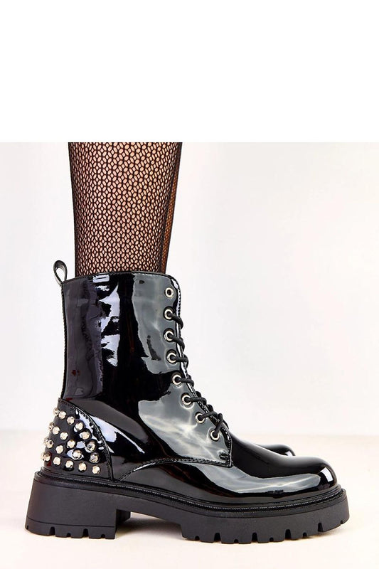 Chic and stylish Solea patent leather ankle booties adorned with glamourous studs, offering comfort with a rounded toe and stable 5.5 cm heel, ideal for cooler days.