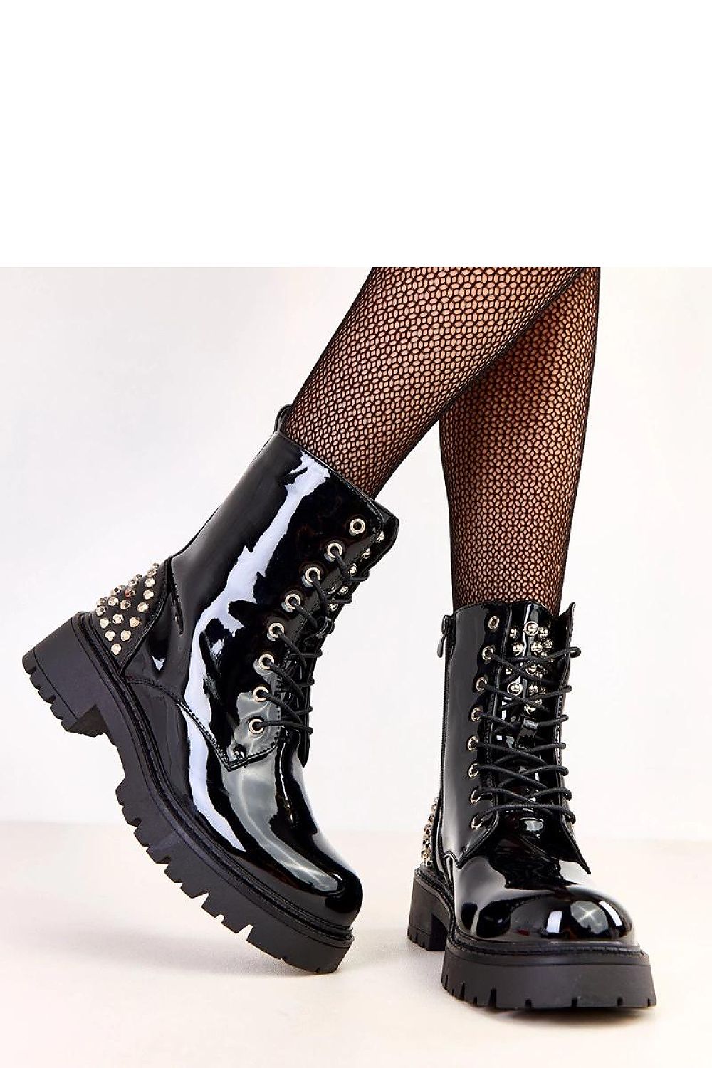 Sophisticated pair of Solea women's ankle-length booties in glossy patent leather, showcasing elegant studs and a 5.5 cm heel, perfect for work or casual occasions.