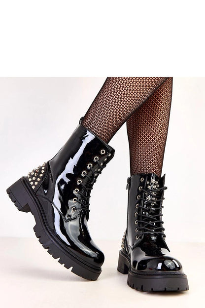 Sophisticated pair of Solea women's ankle-length booties in glossy patent leather, showcasing elegant studs and a 5.5 cm heel, perfect for work or casual occasions.