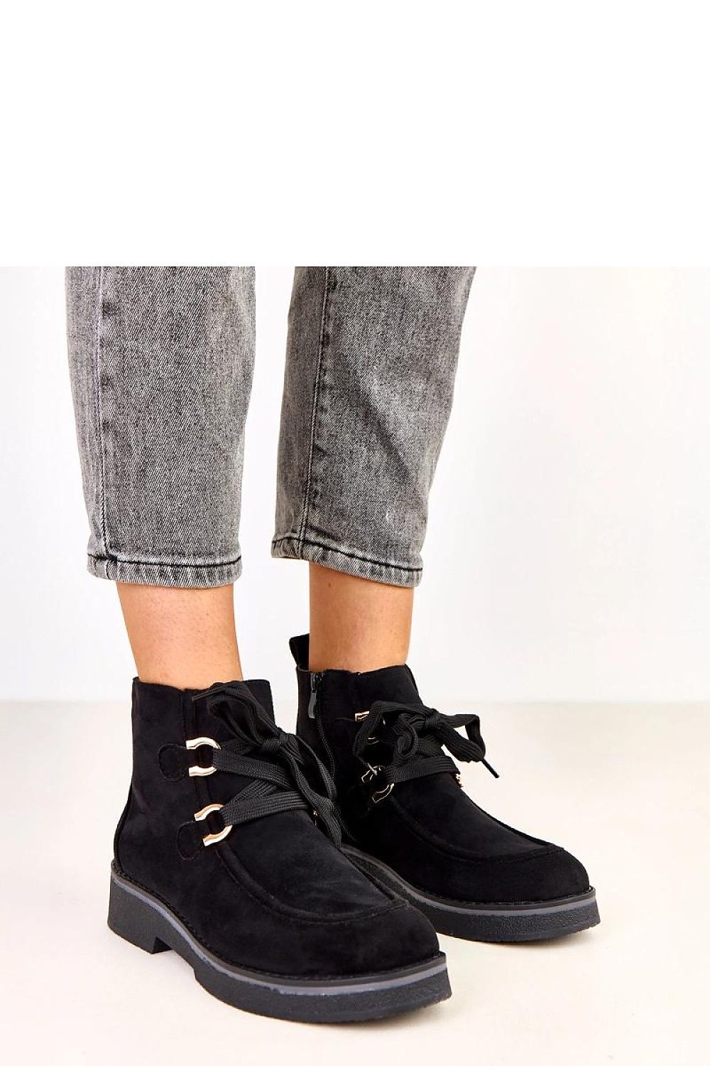 Close-up of Solea Women's ankle boots showcasing fashionable decorative laces and a comfortable round toe design, ideal for chic autumn outings.