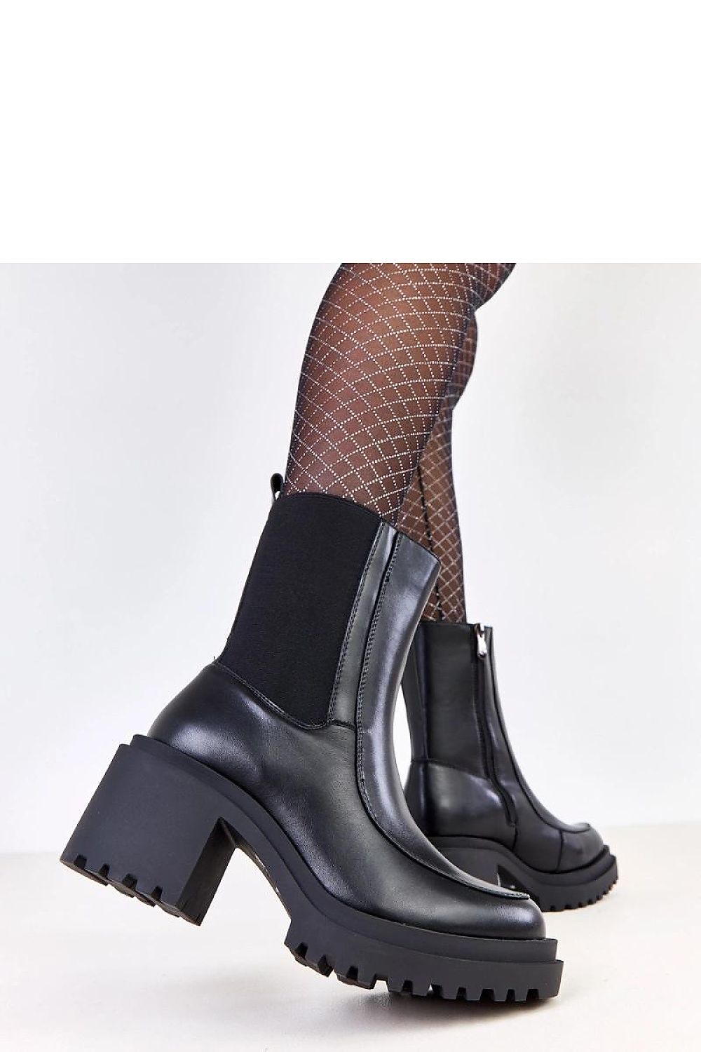 Versatile Solea vegan leather ankle boots, showcasing a sleek silhouette, warm interior, and practical zipper for easy wear during colder seasons.