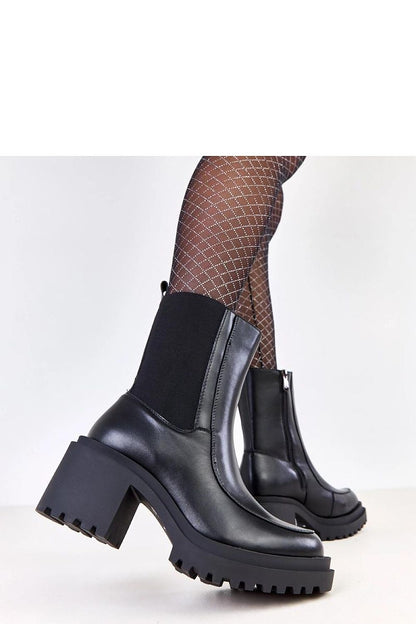 Versatile Solea vegan leather ankle boots, showcasing a sleek silhouette, warm interior, and practical zipper for easy wear during colder seasons.