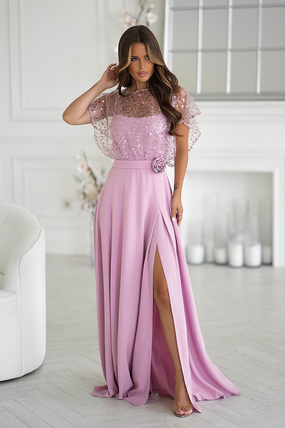 Elegant long dress with sequined bolero by Bicotone, featuring thin straps and a stylish rose belt, ideal for evening wear and special occasions. Available in sizes EU 38-48.