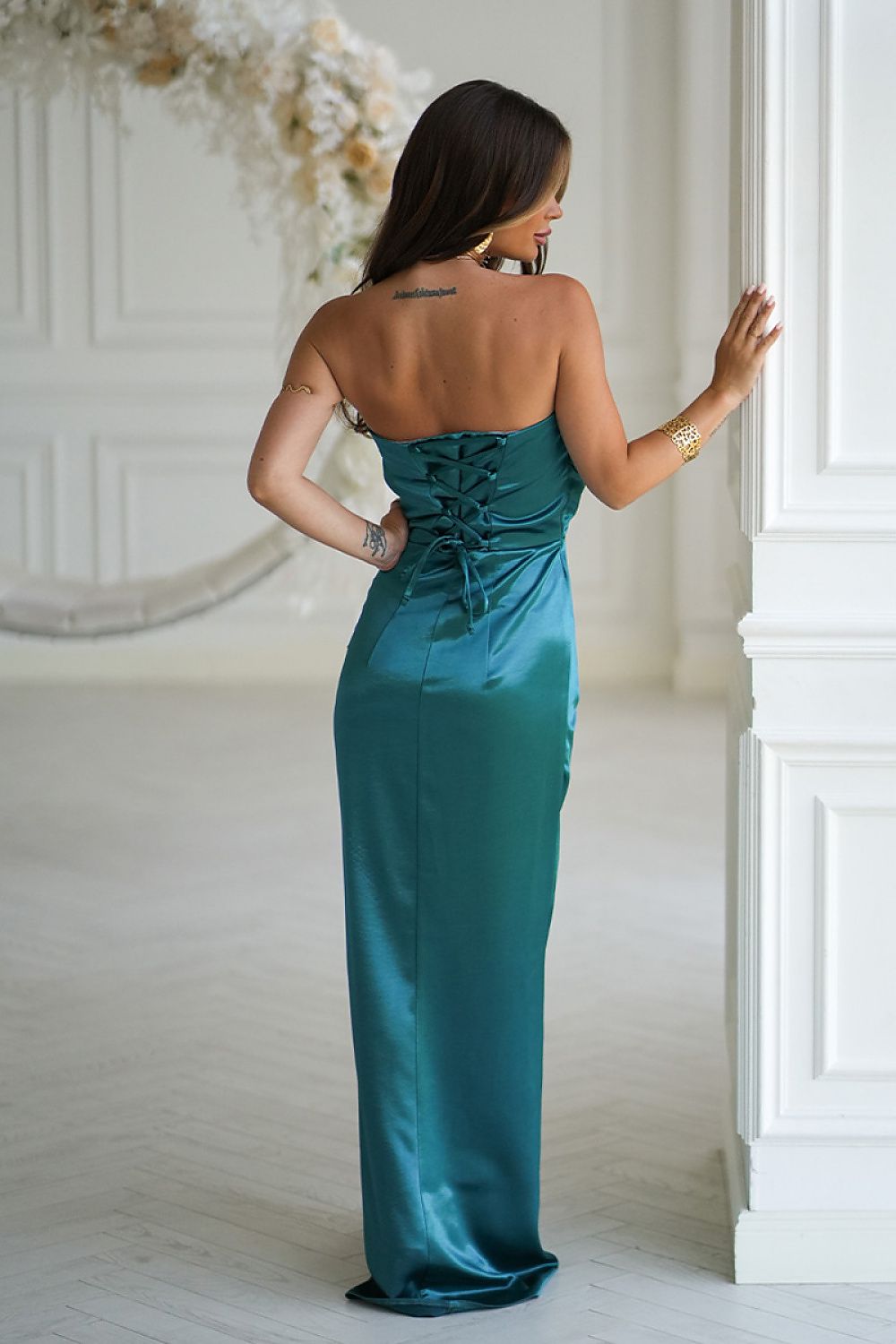 Elegant strapless satin dress by Bicotone featuring a draped rose on the bust and a high slit, perfect for formal occasions and evening wear.