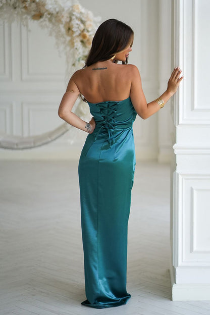 Elegant strapless satin dress by Bicotone featuring a draped rose on the bust and a high slit, perfect for formal occasions and evening wear.