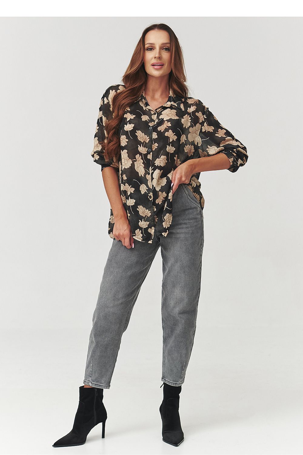 Stylish presentation of the Makadamia floral shirt tucked into high-waisted pants, demonstrating versatility and timeless fashion appeal.