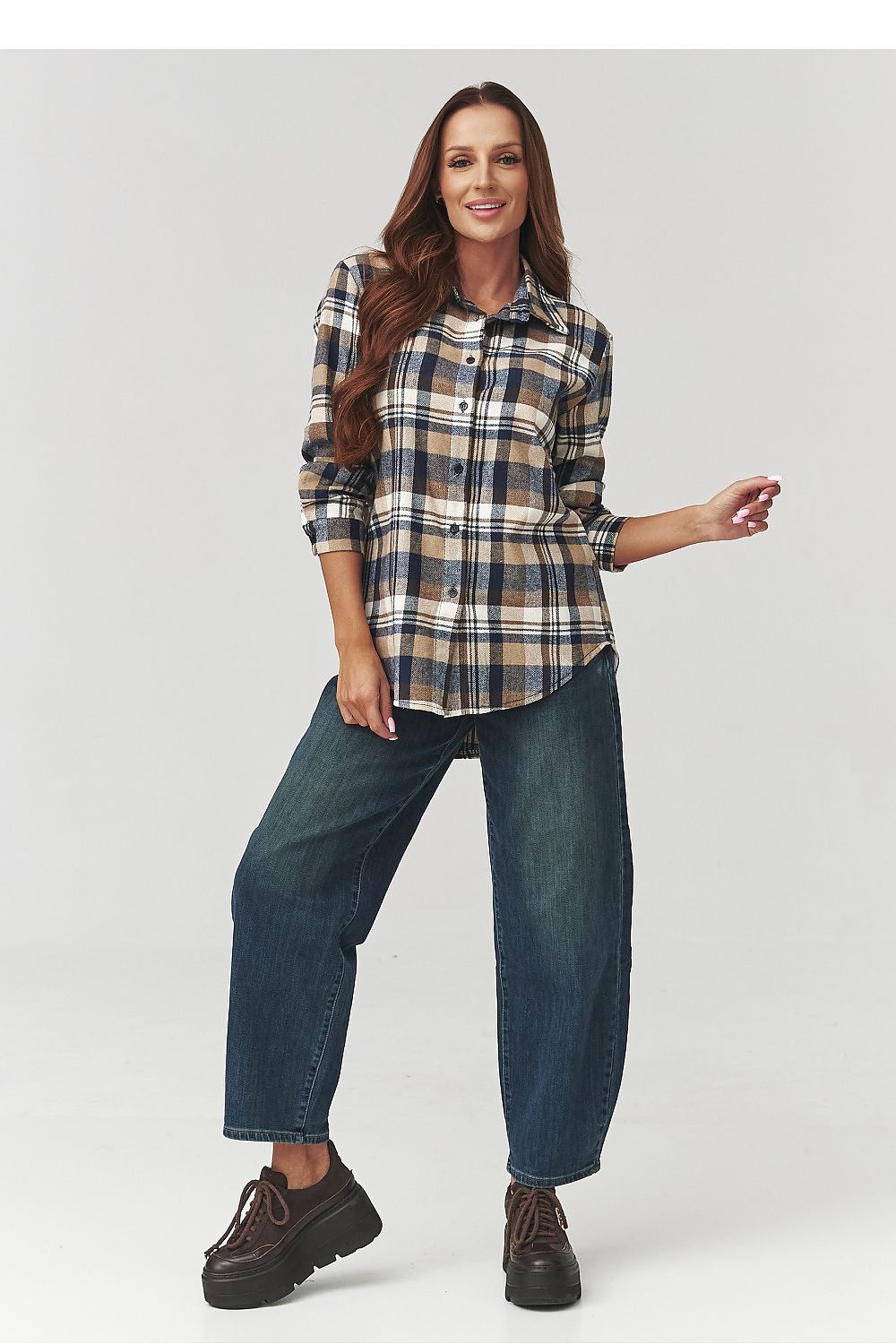 Stylishly layered Makadamia Long Sleeve Cotton Plaid Shirt over jeans, demonstrating versatile styling options for a chic casual look.
