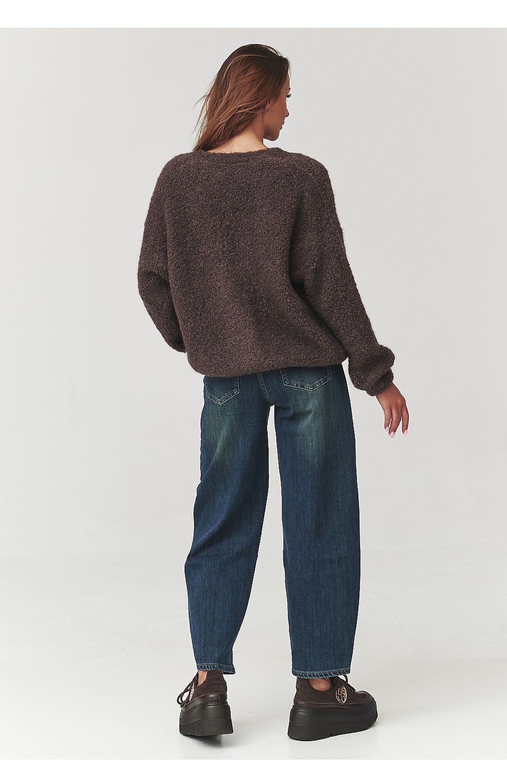 Elegant Makadamia Women's Bouclé Cardigan in a sophisticated setting, highlighting the soft fabric and flattering silhouette, a must-have wardrobe piece.