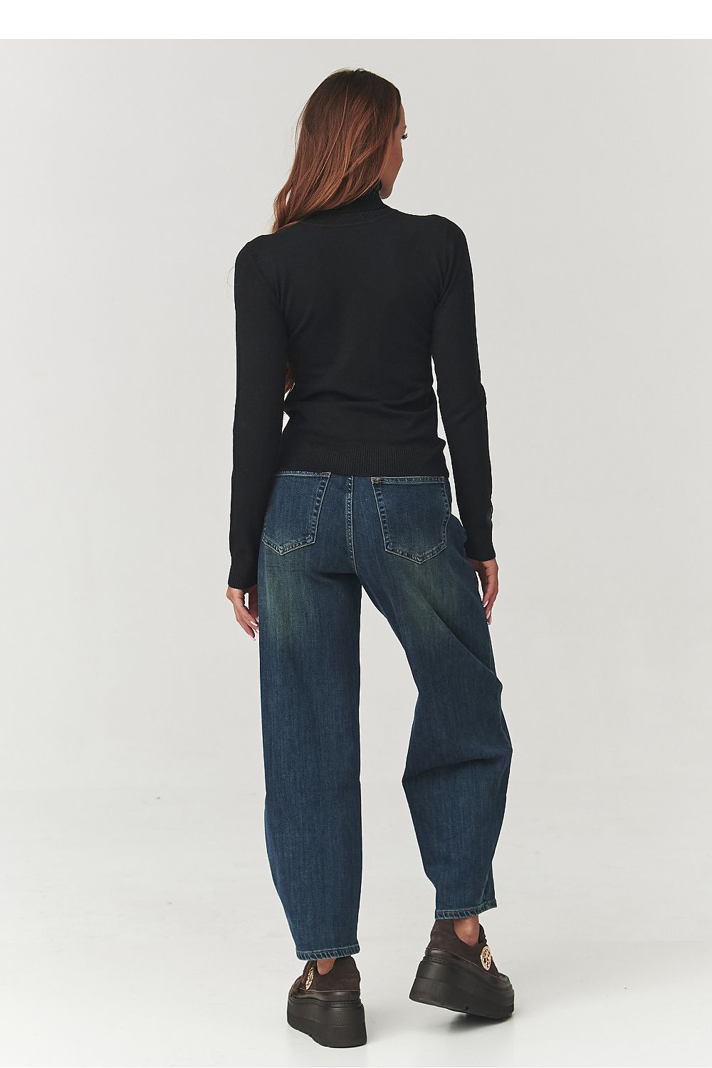 Chic Makadamia Women's Luxury Turtleneck Golf Top in classic black, designed from breathable, elastic material for a flattering silhouette.