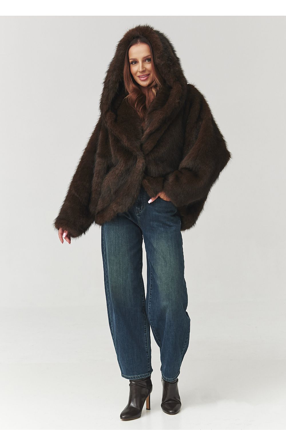 Chic image of Makadamia's brown faux fur jacket with hood, highlighting its fashionable silhouette and warmth for cold weather.