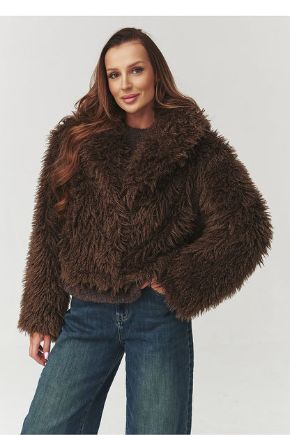 Model wearing Makadamia's luxurious short fur jacket in urban style, combined with jeans and ankle boots for a trendy winter look.
