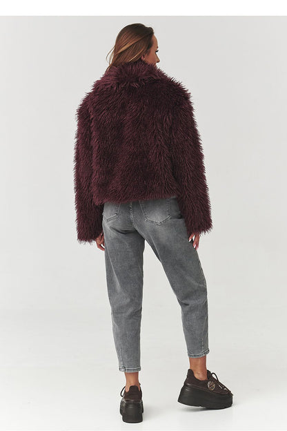 Chic Makadamia fur women's jacket displayed in a fashionable setting, exemplifying luxury and comfort for the winter season.