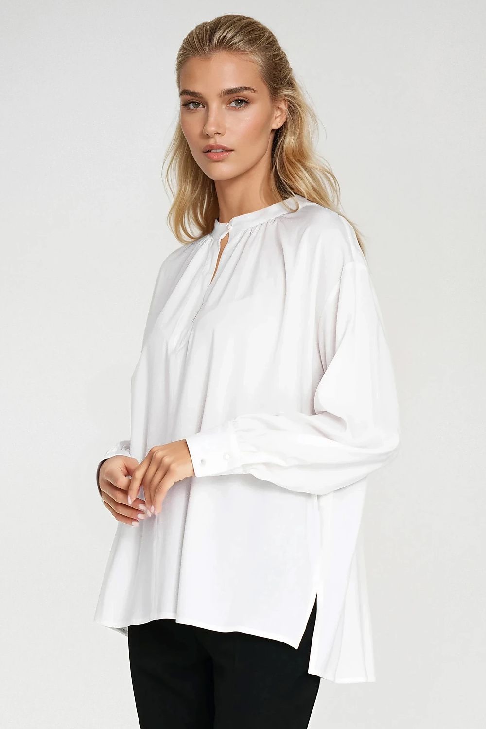 Stylish Nife oversized blouse displayed on a hanger, demonstrating its elegant design and flattering teardrop neckline.