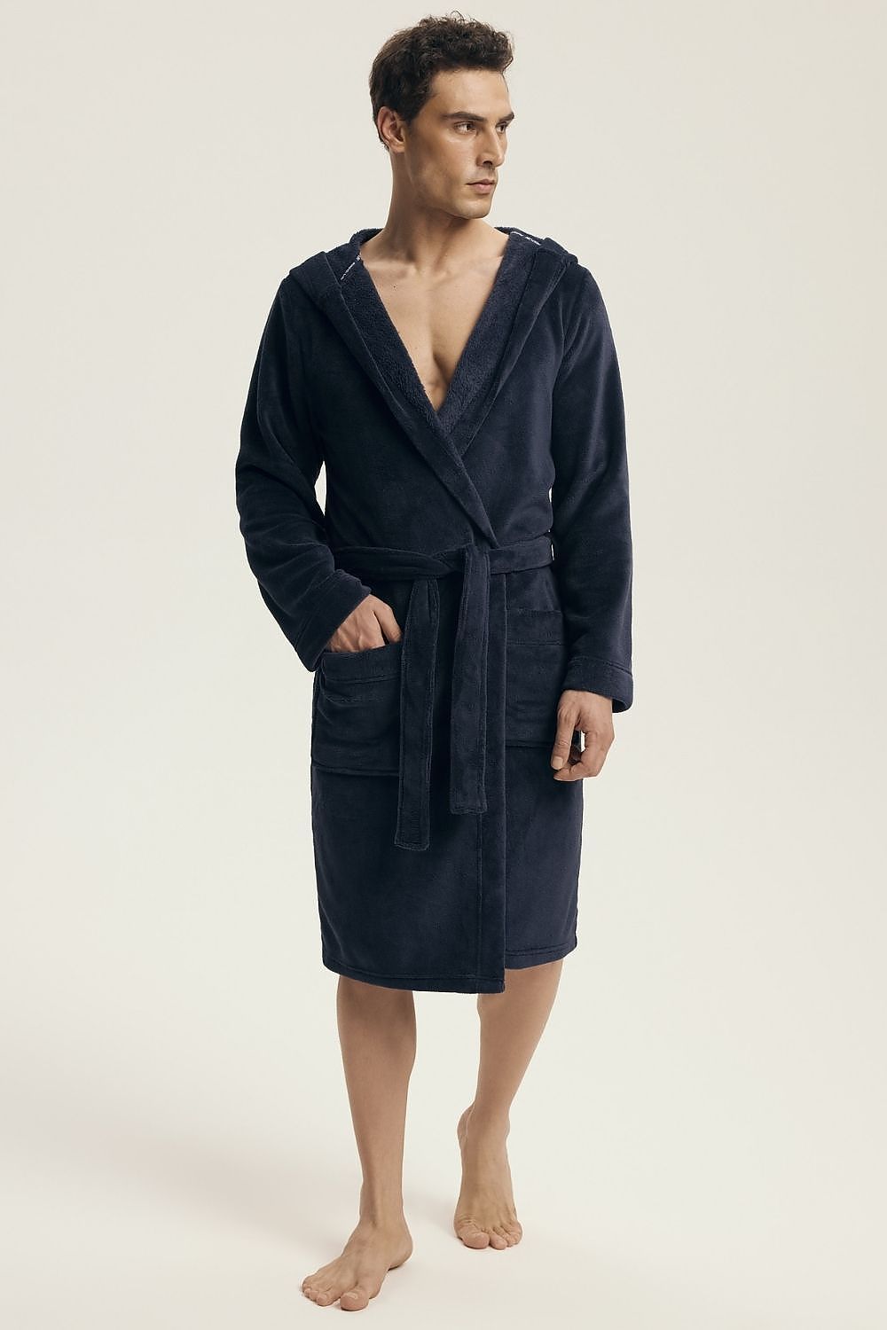Luxury Henderson Men's Hooded Bathrobe in elegant knee-length design, featuring pockets and a belt tie, perfect for relaxation at home.