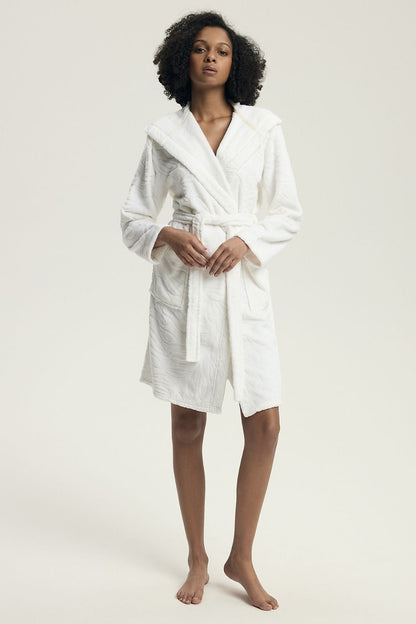 Luxurious women's hooded bathrobe by Henderson, crafted from soft polyester with an elegant embossed pattern, featuring practical pockets and a comfortable cut for premium homewear.
