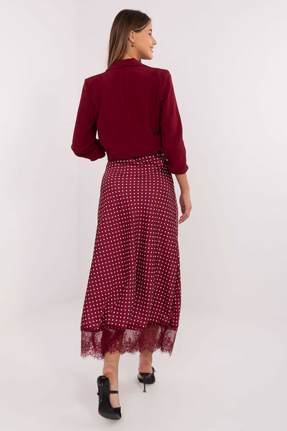 Stylish midi skirt by Rue Paris featuring a comfortable fit with an elastic waist, adorned with intricate lace detailing and a charming polka dot design.