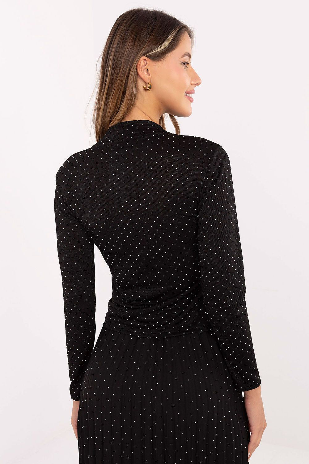 A stylish model wearing the elegant fitted turtleneck blouse by Rue Paris, perfect for formal occasions or parties.