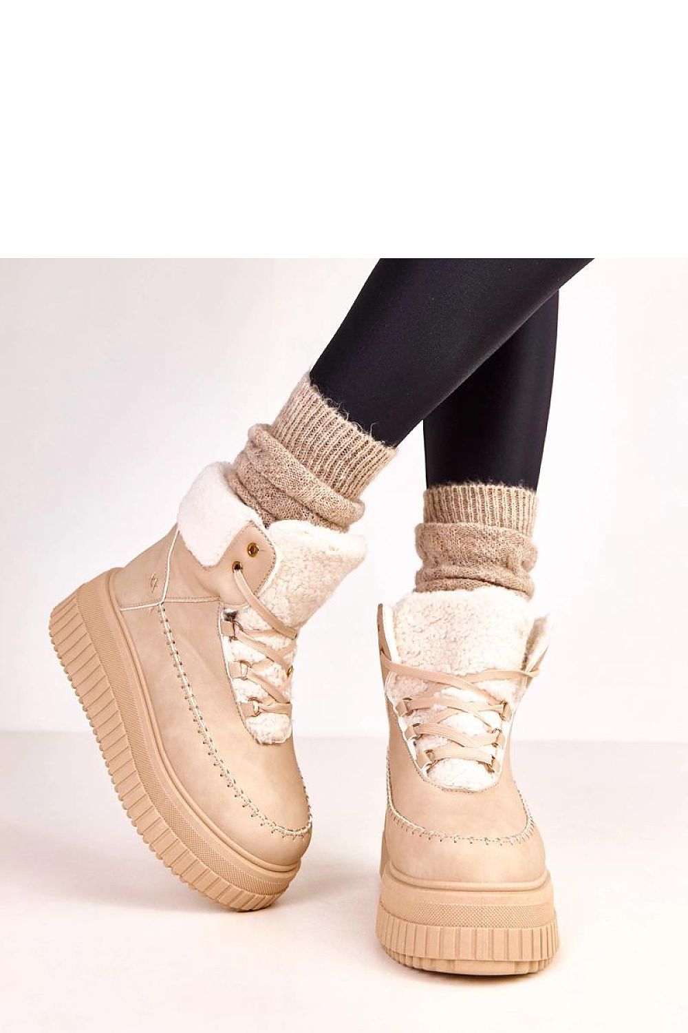 Elegant view of Solea's lace-up sports ankle boots with warm faux fur lining, designed for comfort and style with 12cm shaft height.