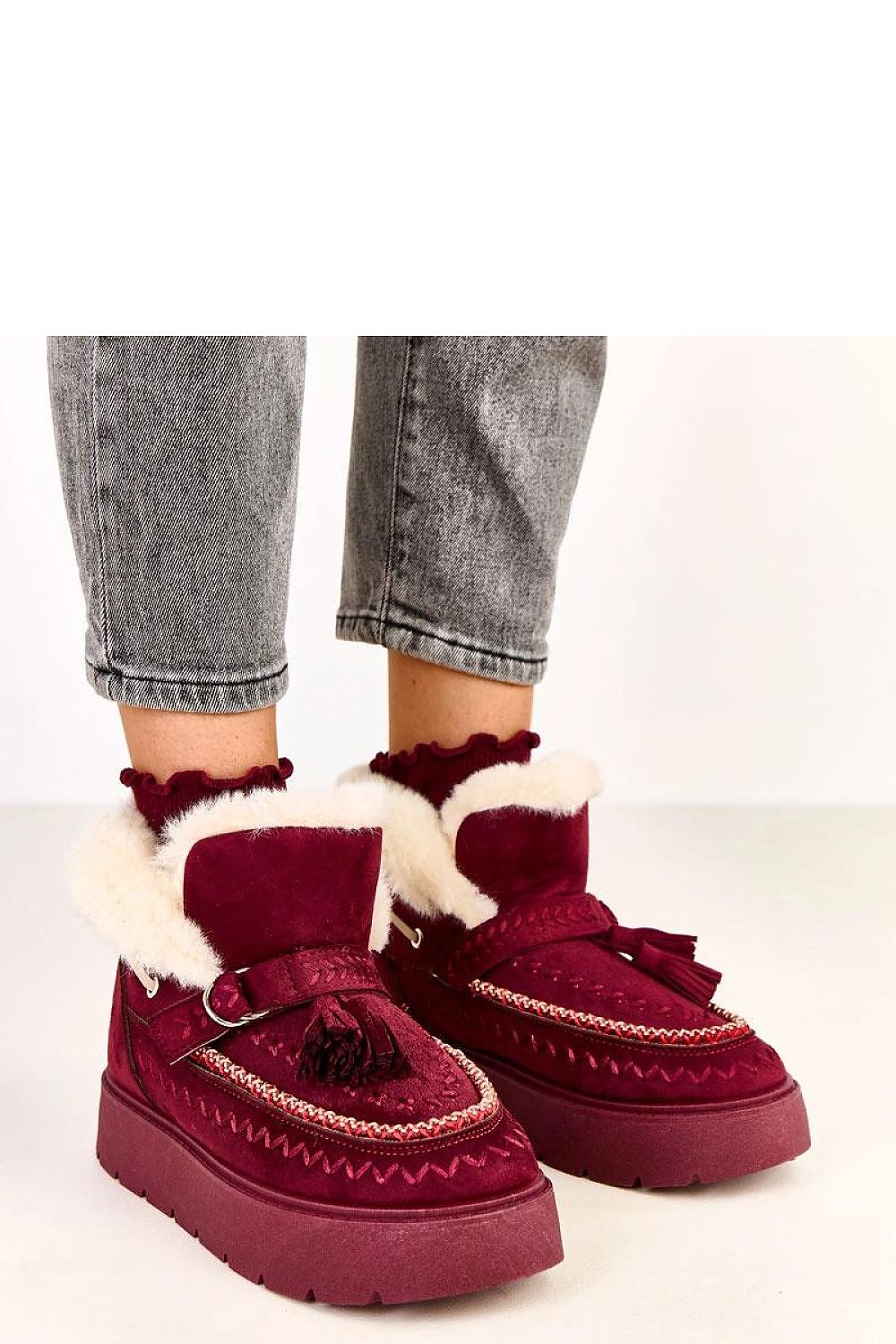 Solea Women's luxurious slip-on snow boots featuring elegant decorative fringes and fur lining, ideal for winter styles.