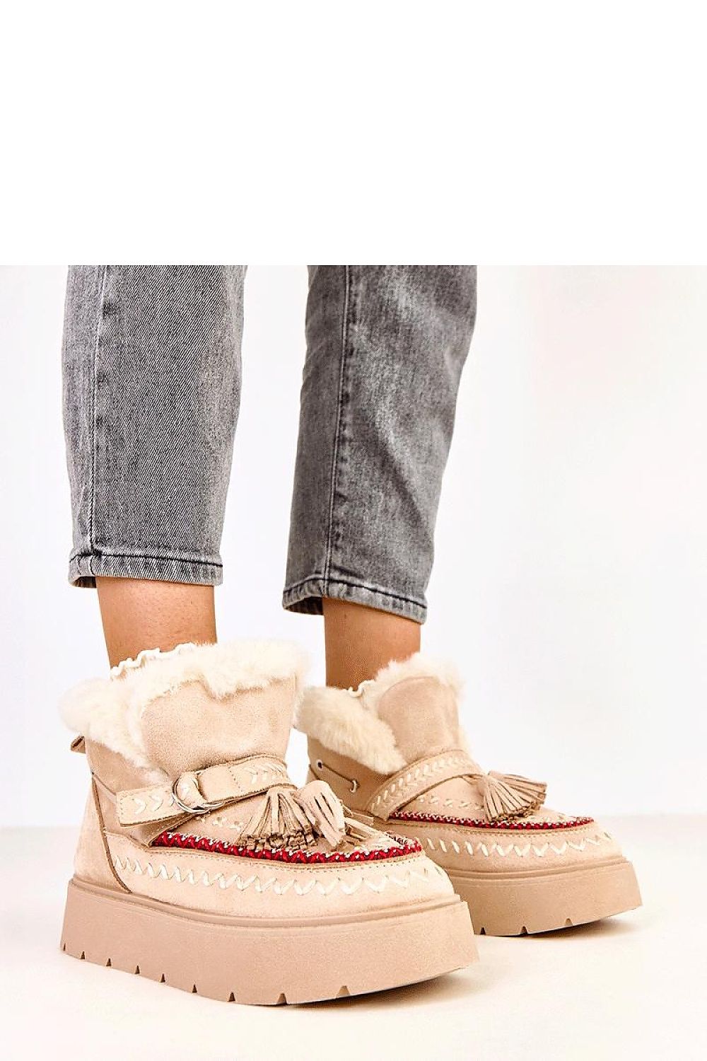 Elegant Solea winter slip-on snow boots in eco-friendly suede with decorative fringes, designed for warm comfort and stylish winter looks.